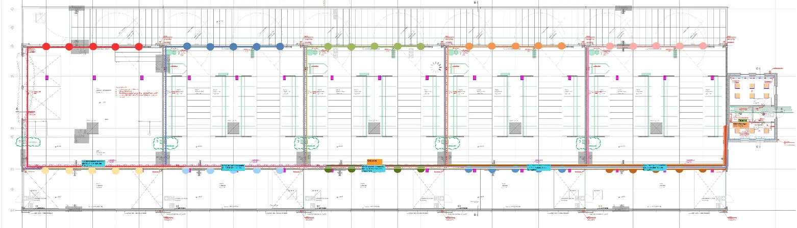 Eine Wissenschaftlerin und ein Wissenschaftler arbeiten hinter einer Glasfassade und mischen Chemikalien mit Großgeräten.